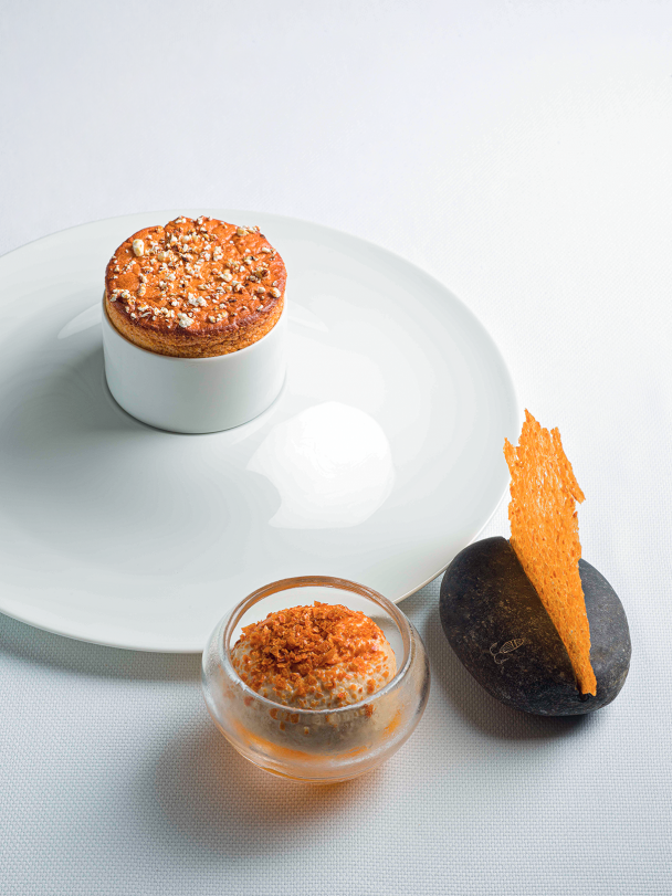 Apple three ways with a soufflé, green apple sorbet, and a dried apple skin chip with almonds.
