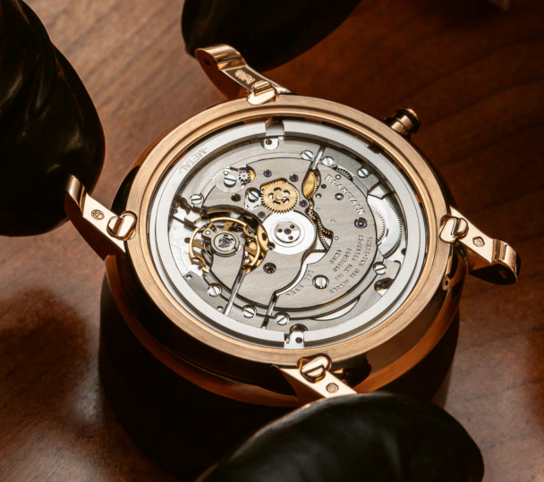 When the movement is fitted into the case, it is secured by a holding ring, and engages with the correctors under the lugs.