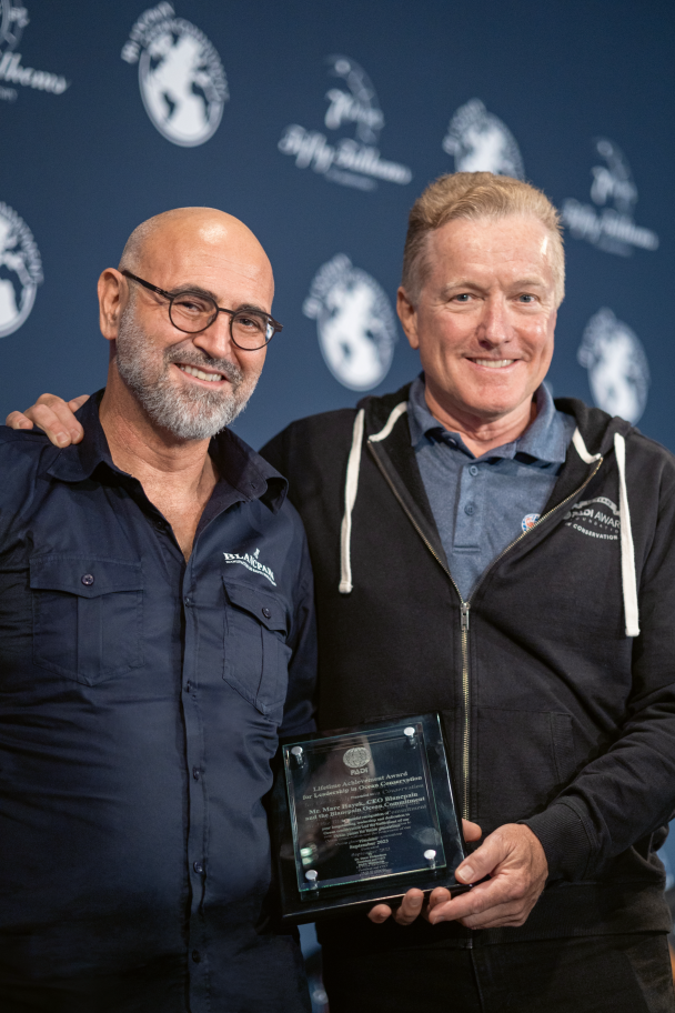 Marc A. Hayek receiving a Lifetime Achievement Award from PADI’s President &amp; CEO Drew Richardson.