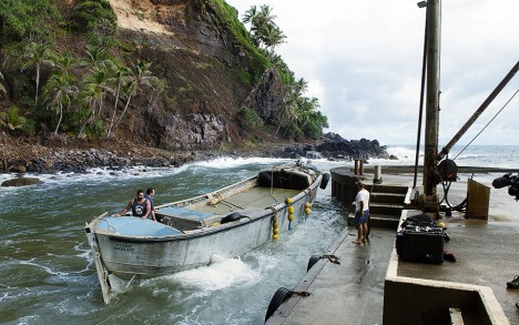 Launching the long boat to go fishing.
